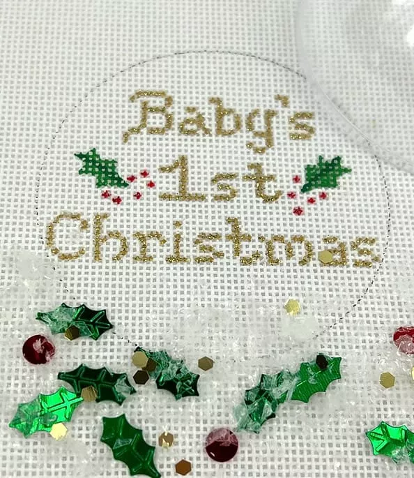 Kate Dickerson Needlepoint – Christmas Ornament w/Clear Dome & Confetti – Baby’s First Christmas